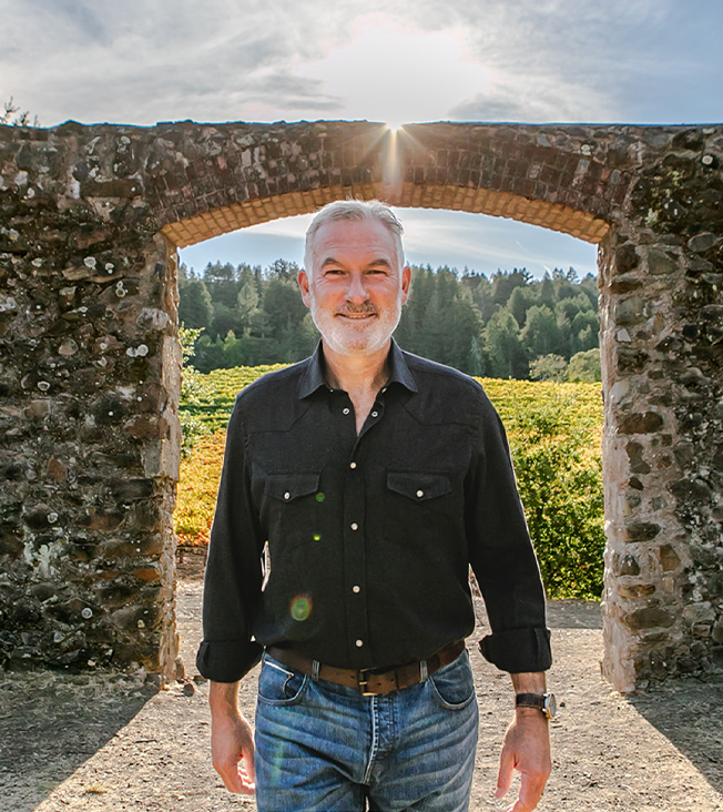 Matt walking in front of a stone archway