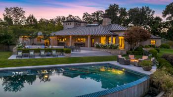 13200 ARNOLD DRIVE GLEN ELLEN CA exterior view with pool in foreground at dusk